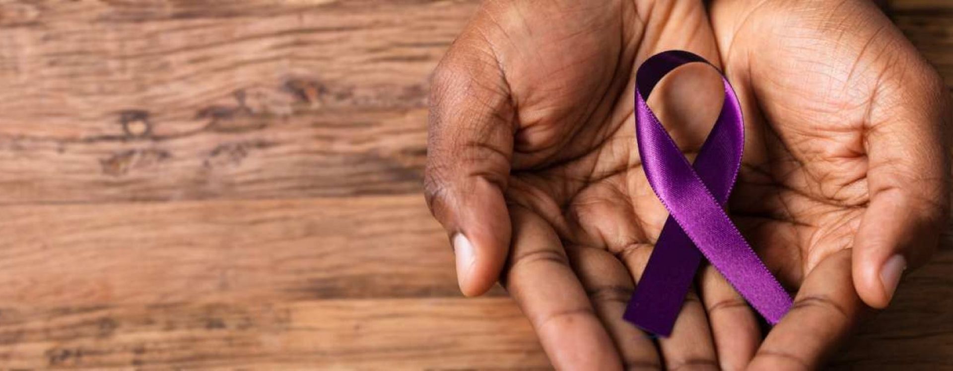 Person holding purple ribbon