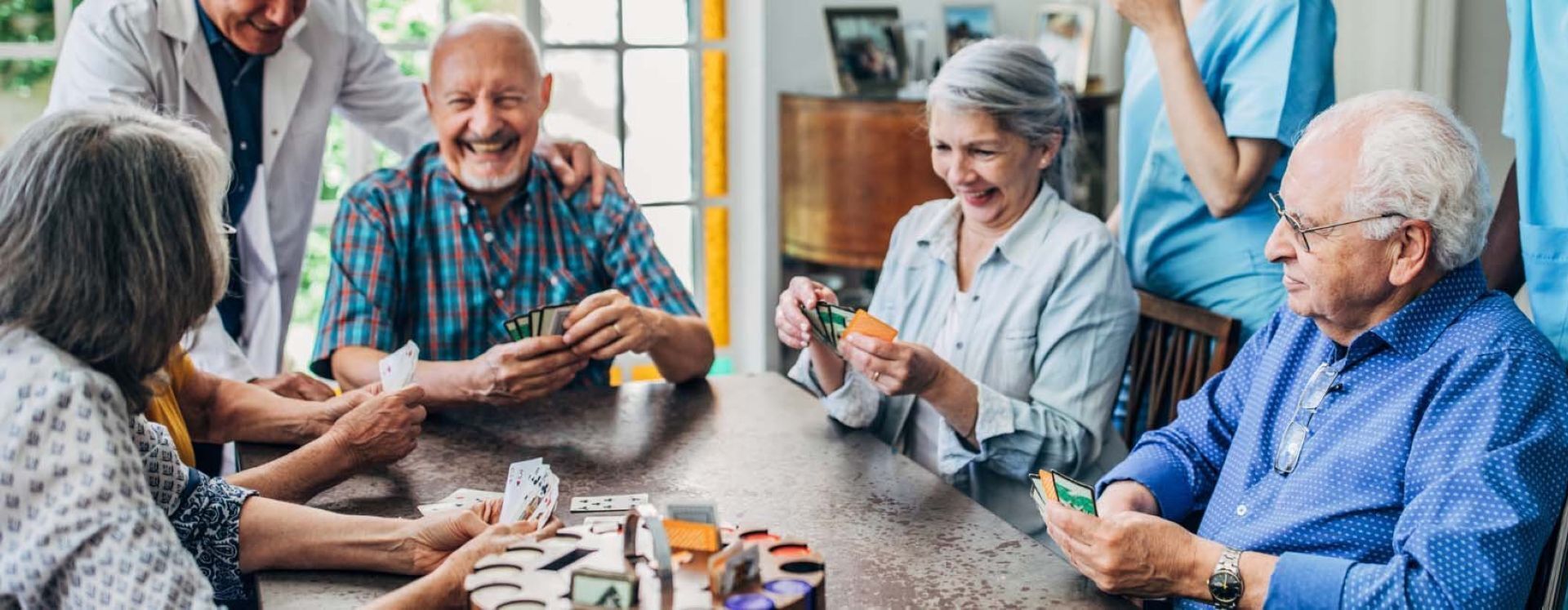 Elderly people playing cards